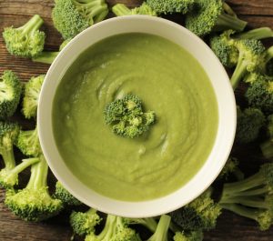 Top view of a broccoli soup in a white bowl