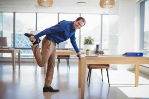 Portrait of smiling executive exercising in office